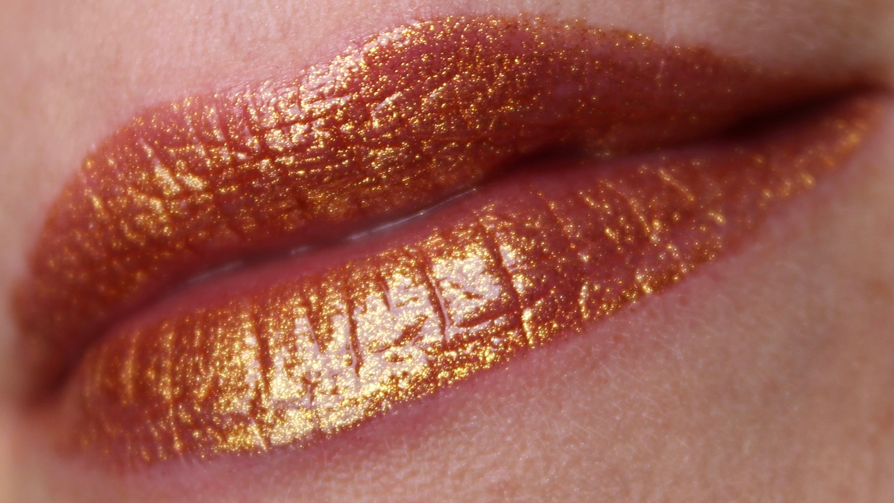 The Melted Gold Liquified Gold Lip Gloss is infused with real gold and offe...